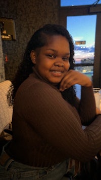 a young woman sitting at a table in a restaurant