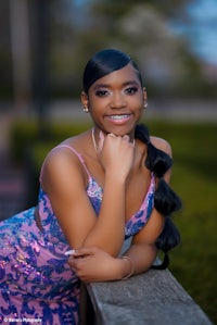 a young woman in a pink dress is posing for a photo